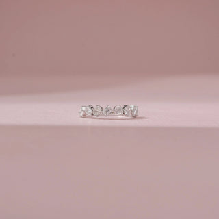 Front view of a 14KT White Gold diamond band featuring alternating round, pear and baguette-cut diamonds.
