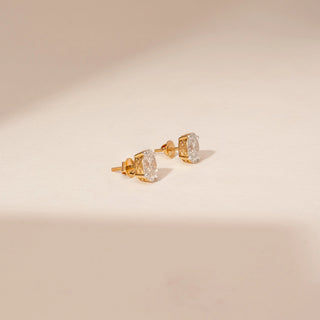 Side view of 14KT Yellow Gold diamond earrings featuring oval centre diamonds with surrounding diamond accents in stud settings.