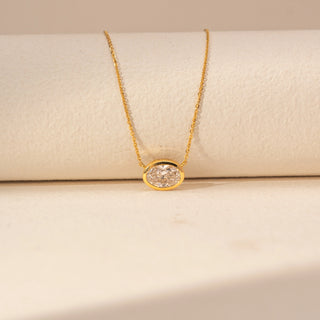 Close-up view of Oval Solitaire Diamond Pendant in 14KT Yellow Gold, featuring a bezel-set oval lab-grown diamond on a fine chain.