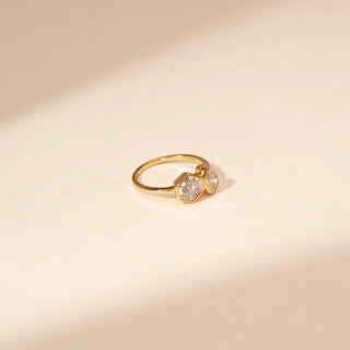 Side view of a 14KT Yellow Gold diamond ring with adjacent hexagonal and pear-shaped centre diamonds.