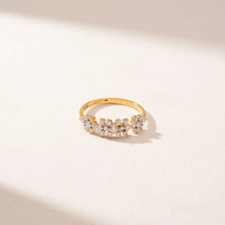 Close-up view of a 14KT Yellow Gold diamond ring featuring a floral cluster design with round diamonds arranged in a row.