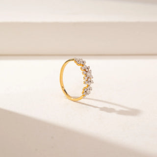 Angled view of a 14KT Yellow Gold diamond ring featuring a floral cluster design with round diamonds arranged in a row.