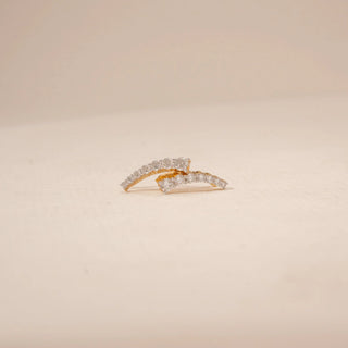 Angled view of curved diamond drop earrings in 14KT Yellow Gold, featuring a row of round diamonds.