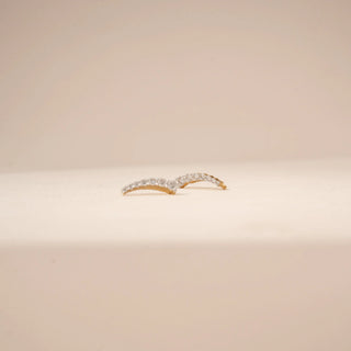 Angled view of curved diamond drop earrings in 14KT Yellow Gold, featuring a row of round diamonds.
