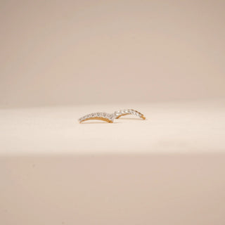 Close-up view of curved diamond drop earrings in 14KT Yellow Gold, featuring a row of round diamonds.