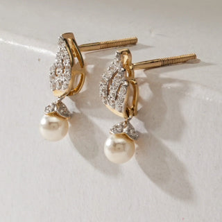 Pair of Pearl Drop Spiral Diamond Earrings in 14KT Yellow Gold, featuring diamond-studded spiral tops with round pearl drops, displayed upright with Bombay screw backs visible.