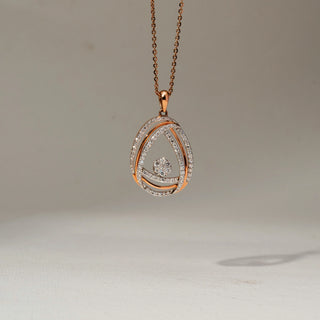Front view of a rose gold teardrop pendant necklace featuring pavé-set diamond curves and a floating round diamond cluster centerpiece, suspended from a delicate chain.