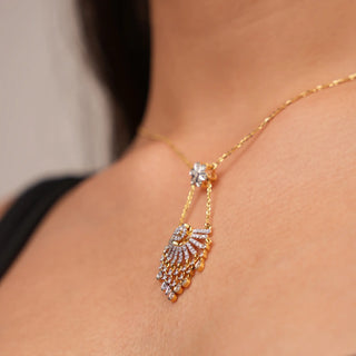 Side view of a female Necklace Necklace on the model's neck crafted with 0.865-carat diamond and 14 KT yellow gold secured with a spring lock . The female Necklace of size 16  showcases a radiant sunray design, with the central diamond enhancing its brilliance