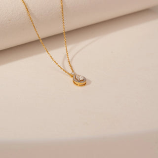 Angled view of Graceful Pear Teardrop Diamond Necklace in 14KT Yellow Gold, featuring a pear-cut lab-grown diamond.
