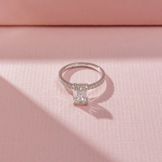 Top view of Emerald-Cut Solitaire Diamond Ring in 14KT White Gold, featuring a rectangular lab-grown diamond and pavé-set band.
