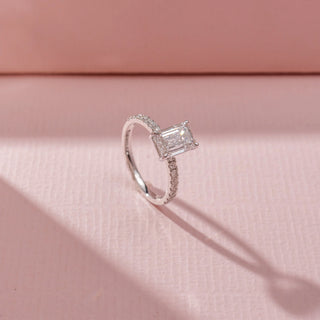 Angled view of Emerald-Cut Solitaire Diamond Ring in 14KT White Gold, featuring a rectangular lab-grown diamond and pavé-set band.