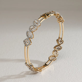 Elegant 14KT Yellow Gold diamond bangle with alternating marquise, oval, and kite-shaped motifs, set with EF colour, VVS clarity diamonds.