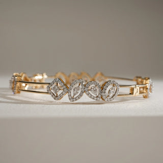 Shaped Harmony Multi-Cut Diamond Bangle in 14KT Yellow Gold, featuring marquise, oval, and kite-shaped diamond outlines with EF colour, VVS clarity diamonds.