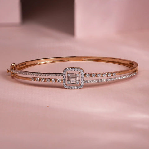 Reia's rose gold 14 KT bracelet with lab grown baguette and round EF-VVS diamonds, featuring a bold central halo setting flanked by dual diamond-studded rows, exuding modern luxury with precision craftsmanship