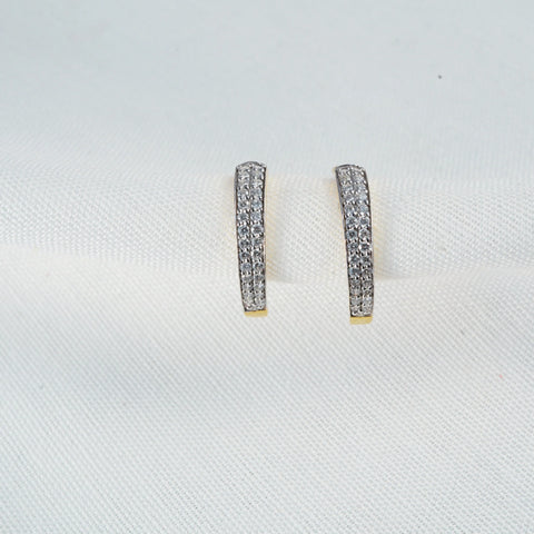 Top view of a pair of 14 KT yellow gold stud earrings displayed on a white background. Each earring features an elongated rectangular design adorned with multiple small diamonds set in two rows. The studs have a total diamond carat weight of 0.35, with each individual stone measuring 0.006 carats. The total gross weight of the pair is 1.62 grams. These elegant earrings are secured by a Bombay screw-type closure, highlighting the contrast between the sparkling diamonds and the yellow gold base.
