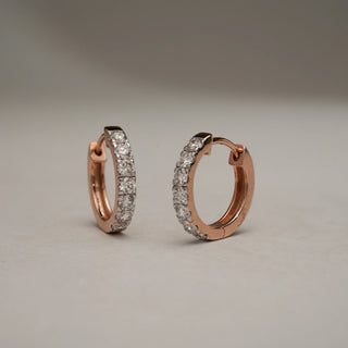 Close-up of Gold Bloom Drop Diamond Earrings in 14KT Rose Gold, designed as elegant hoops adorned with EF-VVS lab-grown round diamonds, displayed on a neutral background with soft light.