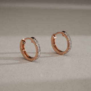 Gold Bloom Drop Diamond Earrings in 14KT Rose Gold, featuring round EF-VVS lab-grown diamonds set along a delicate hoop design, placed on a neutral surface with soft lighting.