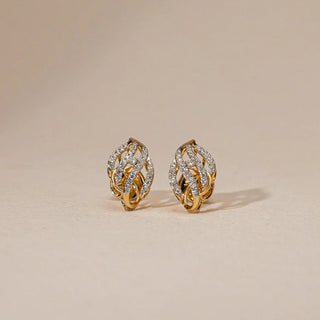 Front view of RÃ©iaâ€™s Twisted Flame Diamond Stud Earrings on a cream background, showcasing the flame-inspired gold silhouette with round EF-VVS lab-grown diamond clusters. The intertwined curves reflect dynamic movement and sculpted brilliance in a compact, elegant form.