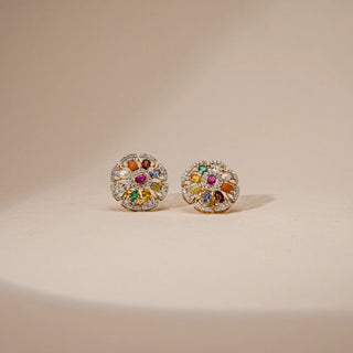 Front view of Reia's Nine-Gem Halo Heritage Earrings on a beige background, showcasing a vibrant Navratna-inspired design with nine sacred gemstones encircled by marquise-cut lab-grown diamonds in hallmarked 14 KT tri-gold. A radiant tribute to tradition, spirituality, and timeless elegance.