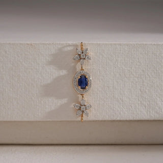 A close-up view of an exquisite 18 KT yellow gold pendant, weighing 1.973g, showcasing its central 0.39 carat round gemstone encircled by 0.500 carats of luminous round EF VVS diamonds. The pendant and a portion of its chain are laid flat on a light beige textured fabric, creating soft shadows, with a blurred light background, highlighting its detailed craftsmanship and brilliant sparkle.