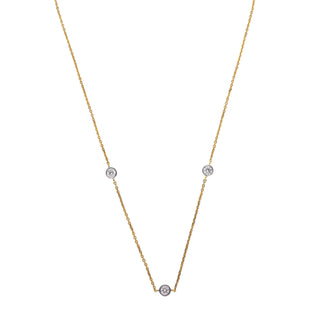 On a white background, a delicate yellow gold necklace adorned with three round-cut diamonds. The diamonds are evenly spaced along the chain, creating a timeless and elegant design. The combination of yellow gold and diamonds creates a versatile and timeless look, making this necklace a valuable addition to any jewellery collection. The image showcases the front view of a 0.7 carat Lab Grown Diamond female Necklace of size 16, secured with a spring lock crafted in 14 KT Yellow Gold