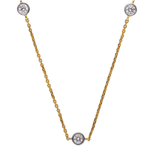 On a white background, a delicate yellow gold necklace adorned with three round-cut diamonds. The diamonds are evenly spaced along the chain, creating a timeless and elegant design. The combination of yellow gold and diamonds creates a versatile and timeless look, making this necklace a valuable addition to any jewellery collection. The image showcases the front view of a 0.7 carat Lab Grown Diamond female Necklace of size 16, secured with a spring lock crafted in 14 KT Yellow Gold