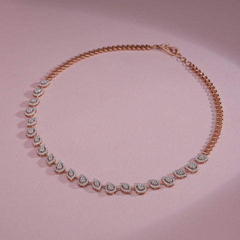 A luxurious 14 KT rose gold necklace, gross weight 19.603g, featuring a continuous line of brilliant round EF VVS diamonds, totaling 2.380 carats, each stone individually set and forming a dazzling, flexible chain. The necklace is displayed in a gentle curve on a smooth, reflective dark surface, with soft lighting highlighting the fire and brilliance of each diamond