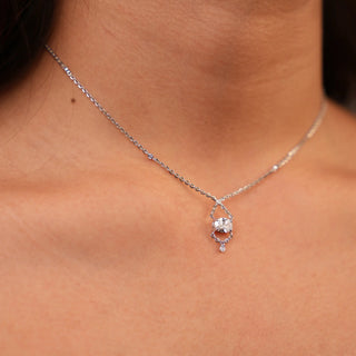 The front view of the Lab Grown Diamond female Necklace showcases a sparkling 0.78-carat diamond with a solitaire of 0.72 carats in an elegant chain-link design weighing 3.04 grams of size 14. Crafted in lustrous 14 KT white gold, the necklace features a delicate chain with small diamond accents secured with a Fish Hook Lock. The centrepiece diamond is held in a unique setting that creates an illusion of infinity, adding a contemporary twist to a classic solitaire pendant worn by a model.