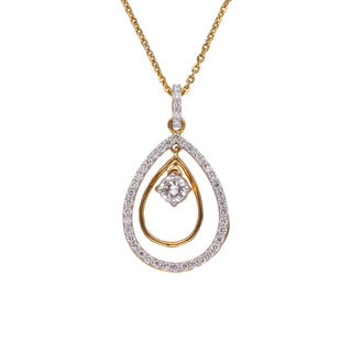 On a white background a delicate yellow gold necklace adorned with a teardrop-shaped pendant set with sparkling diamonds. The pendant features a double-layer design, with a smaller diamond in the centre surrounded by a larger diamond-encrusted oval. Close-up front view of this beautiful female necklace secured with a lobster lock crafted from 14 KT yellow gold and features 0.63 carats of diamonds of size 22.