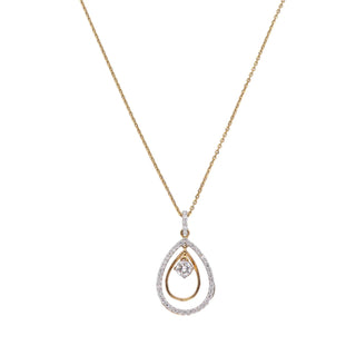 On a white background a delicate yellow gold necklace adorned with a teardrop-shaped pendant set with sparkling diamonds. The pendant features a double-layer design, with a smaller diamond in the centre surrounded by a larger diamond-encrusted oval. Close-up front view of this beautiful female necklace secured with a lobster lock crafted from 14 KT yellow gold and features 0.63 carats of diamonds of size 22