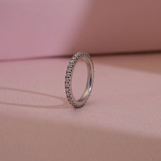 Side view of Reia 14KT Gold Slim Diamond Eternity Band featuring EF VVS round-cut diamonds in a seamless full-circle design, crafted for timeless sparkle and elegant stacking versatility.