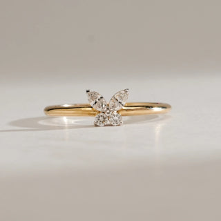 Front view of the Whispering Wings Diamond Ring in 14KT Yellow Gold, featuring marquise and round EF VVS diamonds shaped as butterfly wings, totalling 0.173 carats on a delicate gold band.