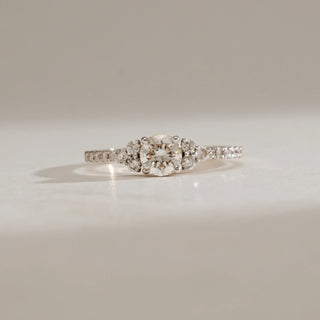 Close-up of Reia’s Celeste Solitaire Diamond Ring in 14KT Yellow Gold, featuring a round-cut EF VVS diamond centre with accent diamonds along the band, totalling 0.61 carats.