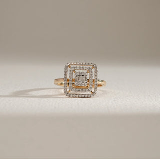 Regal Geometry Cocktail Diamond Ring in 18KT Yellow Gold, featuring a bold square-shaped multi-layer design with concentric rows of baguette and round-cut diamonds, displayed upright on a soft neutral surface.