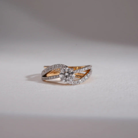 A luxurious 14 KT yellow gold ring, gross weight 4.685g, featuring a prominent central cluster of brilliant round EF VVS diamonds totaling 1.210 carats, arranged in a dazzling floral design. The ring is displayed on a subtly textured dark surface, with soft lighting emphasizing its opulent design and exceptional sparkle