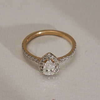 Close-up of the Classic Teardrop Diamond Ring in 14KT Yellow Gold with EF VVS diamonds totalling 0.732 carats, featuring a pear-shaped centre stone framed by a diamond halo.