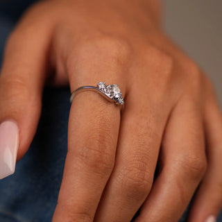 On a model's hand A close-up top of a female ring of size 12, on a model, showcasing a contemporary twist design with intertwining diamond of a trinity. Crafted in 14 KT white gold, the total diamond carat weight is 0.65 carats with a solitaire of 0.51 carats and the weight of the product is 2.15 grams, creating a dazzling and intricate look