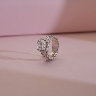 Side view of 18KT White Gold Bold Cushion Diamond Statement Ring showcasing a brilliant round centre diamond with pavé halo and wide EF VVS diamond-studded band for opulent elegance.