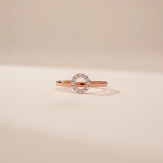 Front view of a 14KT Rose Gold diamond ring with a circular pavé-set open centre and plain band.