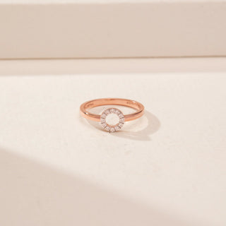 Close-up view of a 14KT Rose Gold diamond ring with a circular pavé-set open centre and plain band.