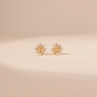 Front view of Sunburst Diamond Stud Earrings in 14KT Yellow Gold, featuring a floral design with baguette and round diamonds.
