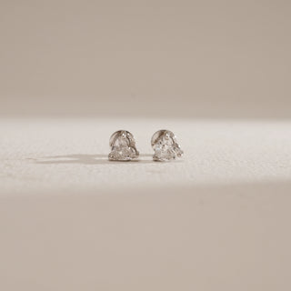 Front view of Cupid’s Love Diamond Stud Earrings on neutral beige background. Elegant white gold 18KT studs with EF colour, VVS clarity lab grown diamonds weighing 2.05 carats in total, featuring solitaires of 1.03 carats each.