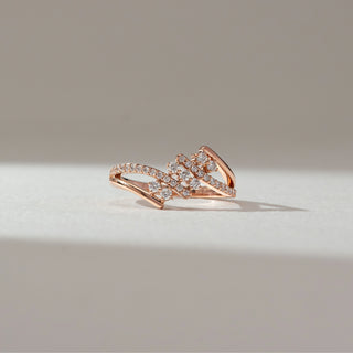 Front view of floral cluster diamond ring in rose gold, featuring round lab-grown diamonds arranged in a blooming cluster with split diamond-studded bands. Set on a soft neutral backdrop, it reflects graceful sparkle.