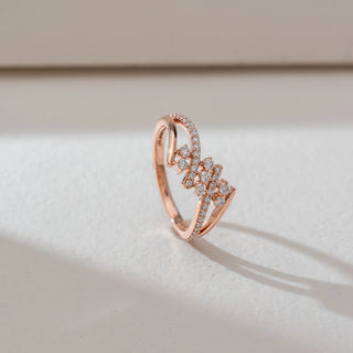 Side angled view of floral cluster diamond ring in rose gold, featuring round lab-grown diamonds in a blooming cluster with split diamond-studded bands. Set on a soft neutral backdrop, it highlights elegant sparkle.