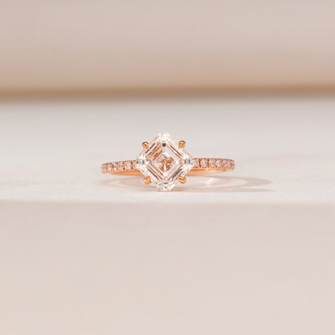 Front view of Kite Set Asscher Diamond Ring in rose gold, featuring a kite-oriented Asscher-cut lab-grown diamond with pavé diamond accents along the band, displayed on a soft beige backdrop.