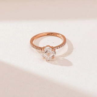 Top view of Kite Set Asscher Diamond Ring in rose gold, showcasing a kite-oriented Asscher-cut lab-grown diamond with pavé diamond accents along the band, displayed on a soft beige backdrop.