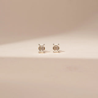 Front view of 14KT Yellow Gold diamond earrings featuring rectangular-cut diamonds in four-prong stud settings.