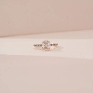 Front view of Reia’s 18 KT Yellow Gold Elegant Oval Diamond Solitaire Ring. Captured against a cream backdrop, it highlights the commanding presence of the stunning oval centre diamond.