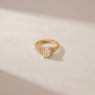 Close-up view of a 14KT Yellow Gold diamond ring featuring an oval centre diamond, pavé-set shoulders and intricate diamond detailing across the wide band.