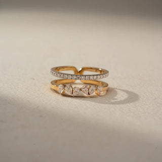 Front view of a floral diamond ring in 14 KT Yellow Gold, featuring a cluster of round lab-grown diamonds nestled within an eye-shaped openwork motif and accented by marquise-cut side diamonds, displayed against a beige backdrop.